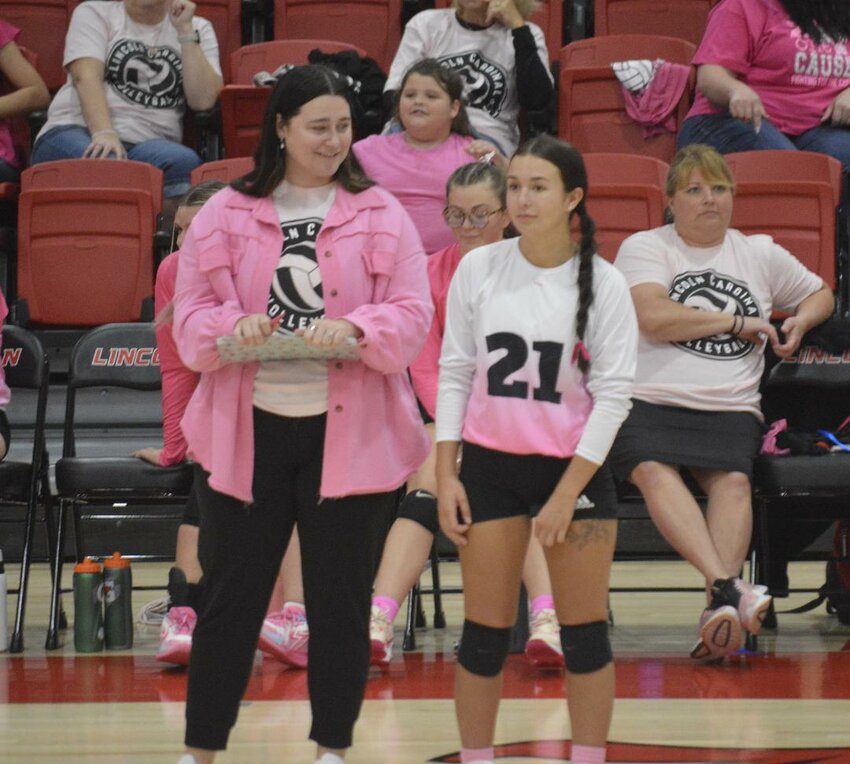 ALL SMILES! Lincoln volleyball head coach Gabbie Spunaugle was all smiles on Tuesday night as she spoke with Sydney Spry. The Lady Cardinals won in three sets over Green Ridge on Pink Out night.