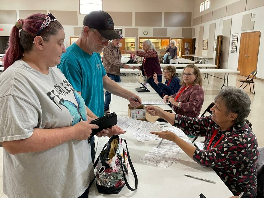 TAKING PART IN A HUGE VOTER TURNOUT for Benton County, Matthew and Ada Wright voted at St. Ann Catholic Church in Warsaw on Tuesday morning. They were assisted by poll worker Dotty Wood.