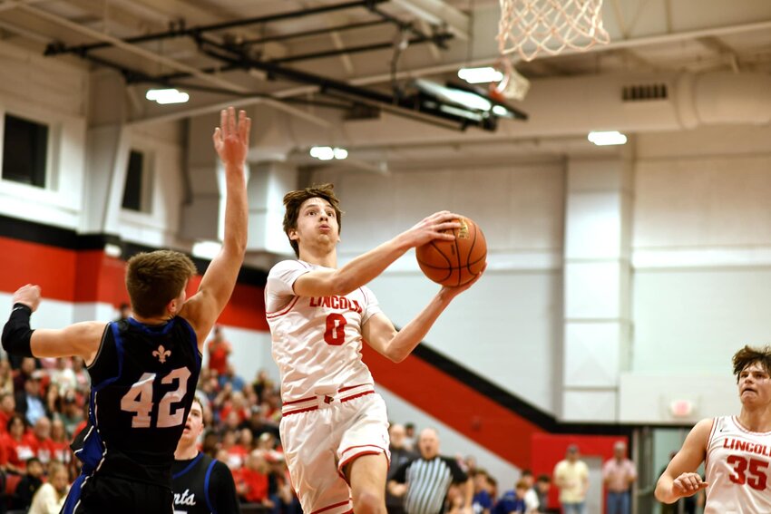 FLYIN' HIGH, the Cardinals' Riley Sanders drove to the basket during a hard fought sectional game at Lincoln on Monday night. Lincoln won 47-46 over St. Paul Lutheran.