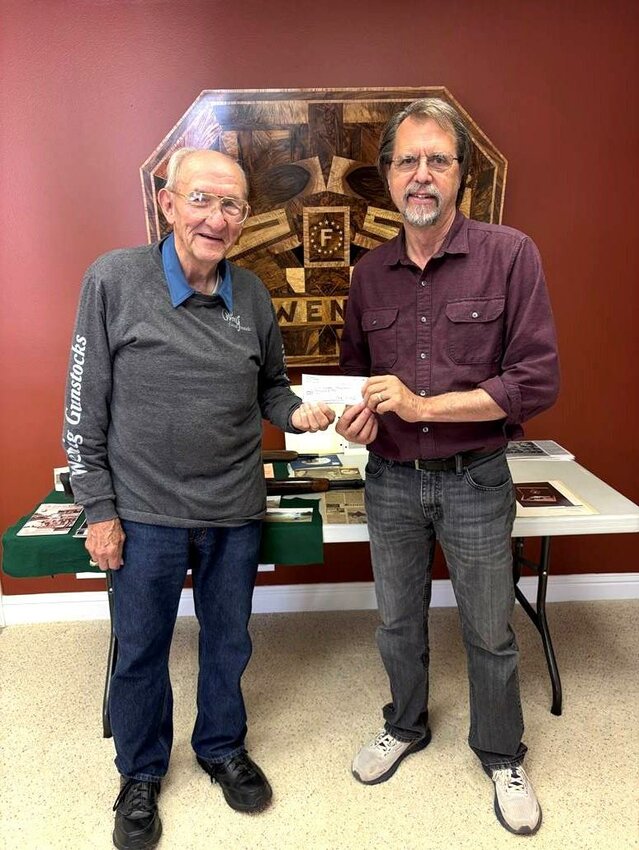 COMING THROUGH, Fred Wenig of Wenig Gunstocks in Lincoln presented his donation for the Playground Expansion on drake harbor to Randy Pogue, Warsaw City Administrator and Planner.