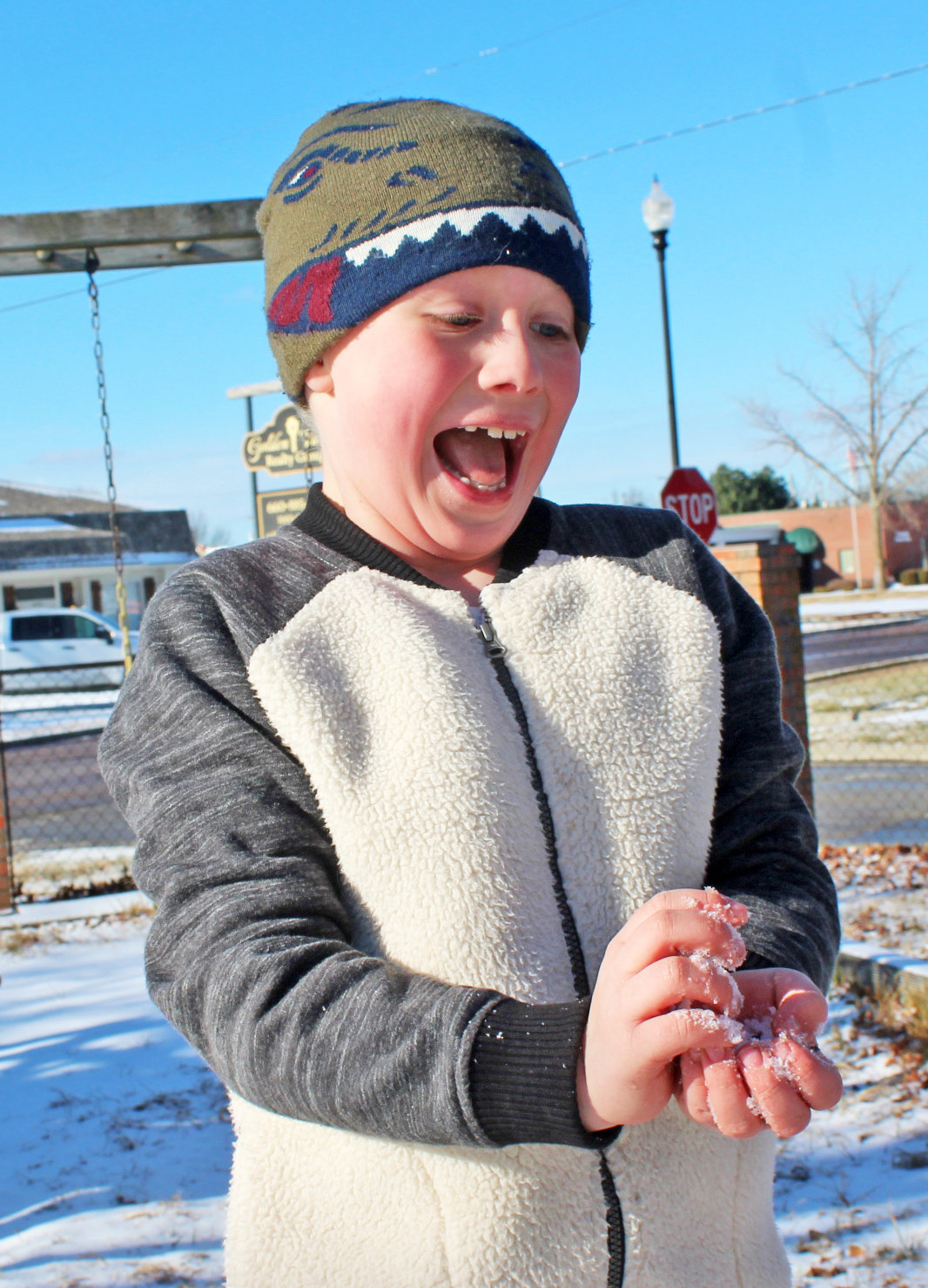 “This is cold,” said Noah Aldridge as he held handfuls of
snow in the air on January 6 at the old playground by the
former Holy Rosary Catholic Church on 2nd Street in
Clinton.