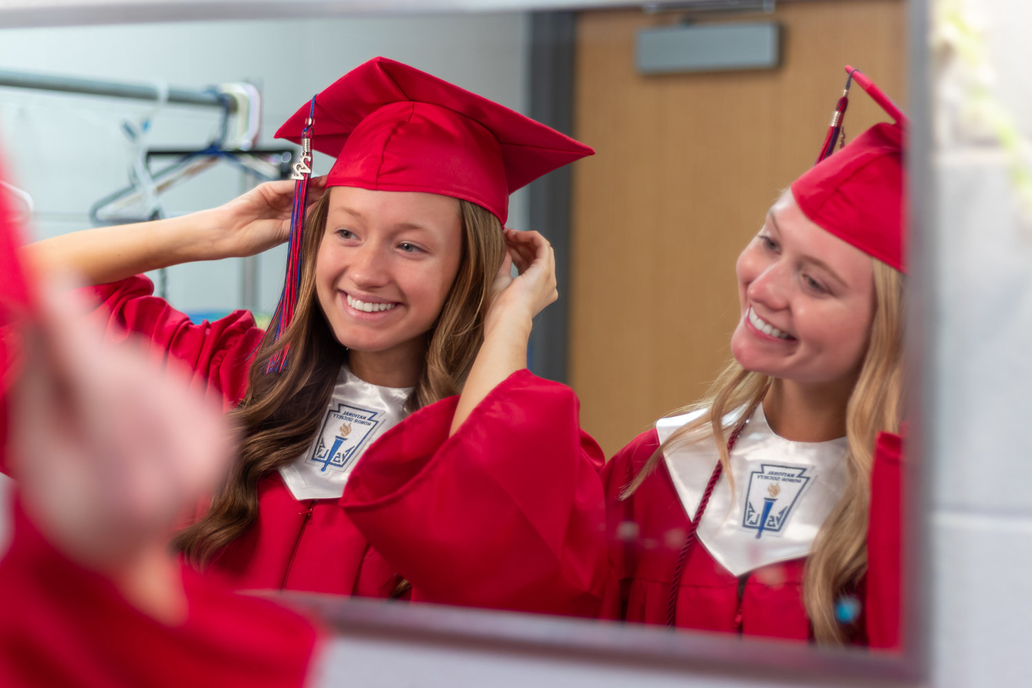 PREPARING FOR THE BIG STAGE at the Clinton High School graduation ceremony, Ashley Berry and Sophie Schilling tried on their caps and gowns on Monday.