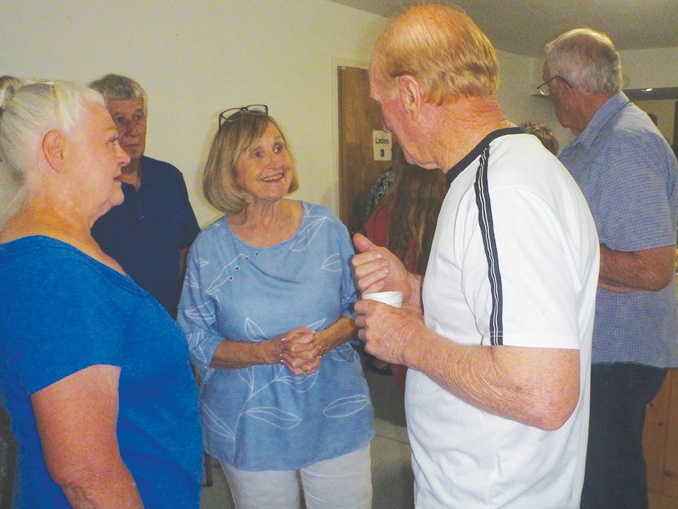 Winnie Scott Tuckness, center, the daughter of a former chapel pastor, visits with Martha Brown Crouch and Don Williams at the Homecoming potluck.