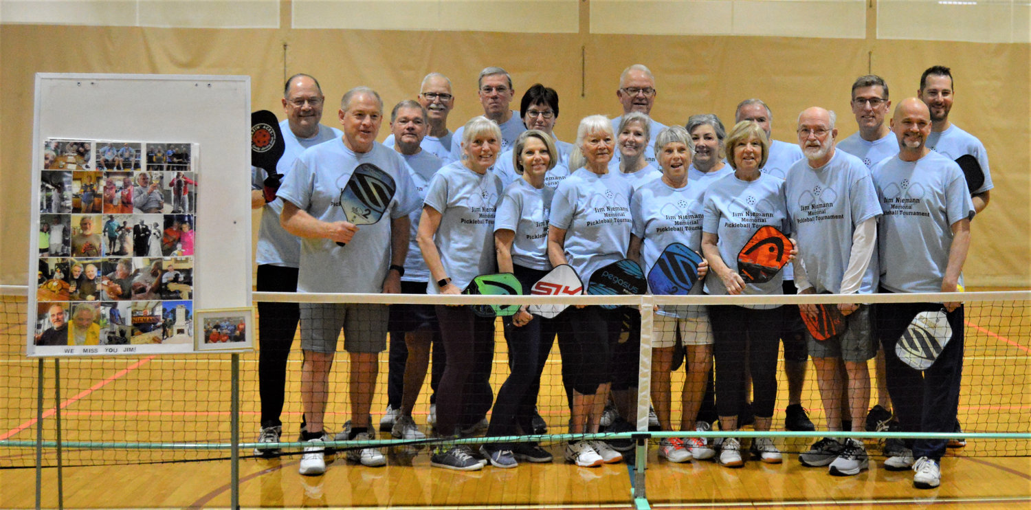 THE 1ST ANNUAL Jim Niemann Memorial Pickleball Tournament: On the left is a collage of Jim and his friends playing Pickleball. Picture: Front row- Jim Sanders, Irene Komer, Paula Thornley, Sheila Bourland, Louis Nieman, Carlene Lowe (4th), John Bailey, Ian Radford (1st). Back Row- Mark Parker (2nd), Dan Turner, Tim Komer, Bill Simms (2nd), Debra Dolly, Janet Huskey, Gene Henry, Kathy Sullivan, Dan Davenport, Greg Shannon, Chad Anderson (3rd). Playing but not pictured, Kevin Sullivan and Christina Brockmeyer.