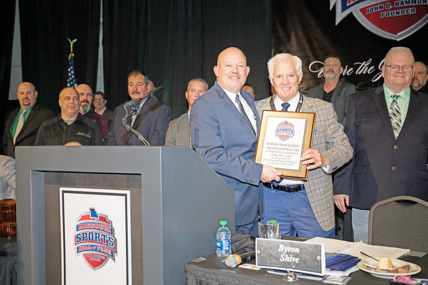 AN HONOR WELL DESERVED, the Warsaw Wildcats football 1988-95 program era was part of the Enshrinement Class of 2024 into the Missouri Sports Hall of Fame at a ceremony held on Sunday.  On behalf of himself and many other coaches, staff and players in attendance, former coach Randy Morrow received the award from CEO/Executive Director of the Missouri Sports Hall of Fame, Byron Shive.