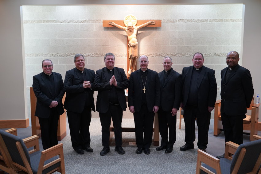 Father Matthew J. Flatley, VF, Father P. Gregory Oligschlaeger, VF, Father Joseph S. Corel, VF, Father Louis M. Nelen, VF, Father Gregory C. Meystrik, VF and Father Roberto M. Ike join Bishop W. Shawn McKnight in the St. Alphonsus Liguori Chapel of the Alphonse J. Schwartze Memorial Catholic Center in Jefferson City, on the day five newly-appointed deans took their Oath of Fidelity to the teaching authority of the Church on April 13.