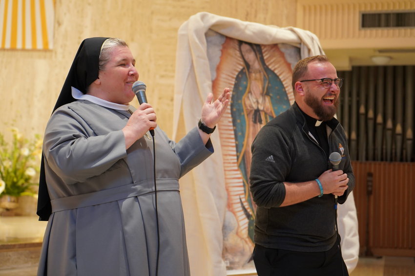 Keynote presenters Sister M. Karolyn Nunes of the Sisters of St. Francis of the Martyr St. George and Father Paul Clark share a funny story during this year&rsquo;s Sixth- and Seventh-Grade Vocation Day.