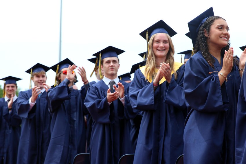 Members of Helias Catholic High School&rsquo;s graduating Class of 2022 stand up and applaud their family, friends and teachers during English instructor Patricia Seifert&rsquo;s address at the Commencement Exercises on May 22.