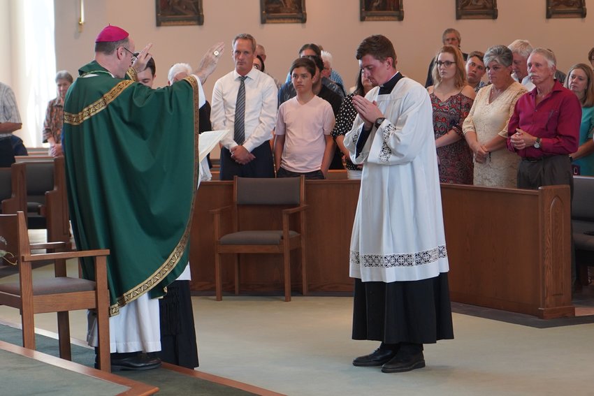 Bishop W. Shawn McKnight admits seminarian Jacob Hartman to candidacy for Holy Orders during Mass on Aug. 6 in St. Andrew Church in Holts Summit.