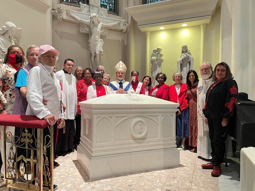 Members of the Julia Greeley Guild gather at the resting place of Servant of God Julia Greeley in the Cathedral Basilica of the Immaculate Conception in Denver after Mass on June 6, the day before the 104th anniversary of &ldquo;Beloved Julia Greeley&rsquo;s&rdquo; death.