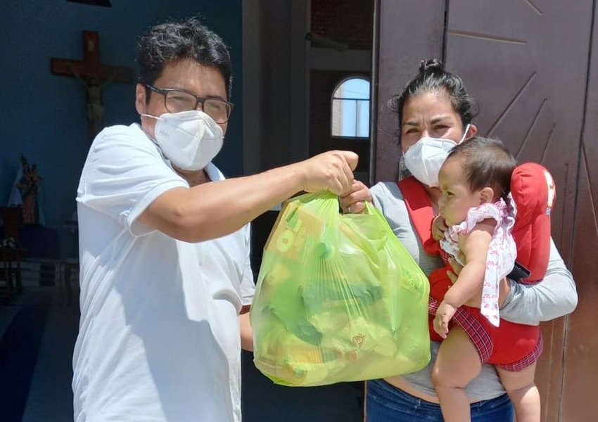 Father C&eacute;sar Anicama ministers to people during their pain and suffering in the Peruvian coastal city of Villa El Salvador while serving with the Missionary Society of St. James the Apostle during the COVID-19 pandemic. Here, he is seen delivering bags of food to people who are hungry.