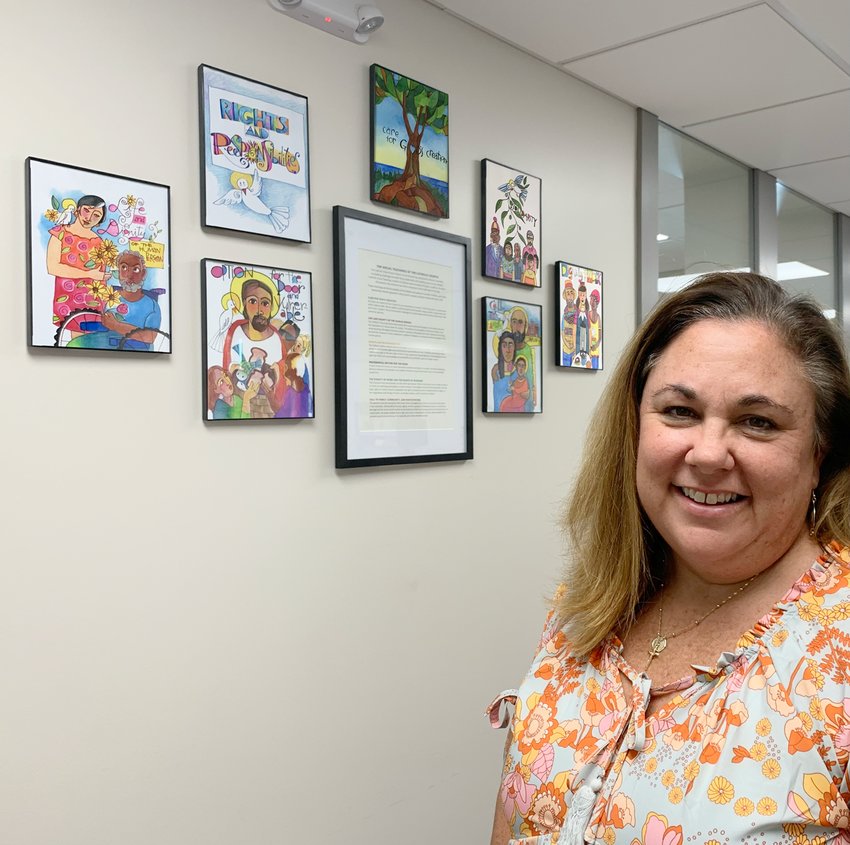 Lori Stoll, Food Programs Coordinator at Catholic Charities of Central and Northern Missouri, brought Brother Mark McGrath&rsquo;s seven prints depicting Catholic Social Teachings to the waiting area of the central offices at 1015 Edmonds Street, to serve as a reminder that participating in the work of Catholic Charities is a participation in the ministry of Christ.