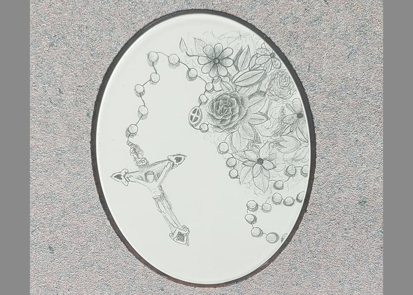 Claire Huntley&rsquo;s pencil drawing of a rosary and flowers has been reproduced and incorporated into Deacon Christopher Wickern&rsquo;s headstone.