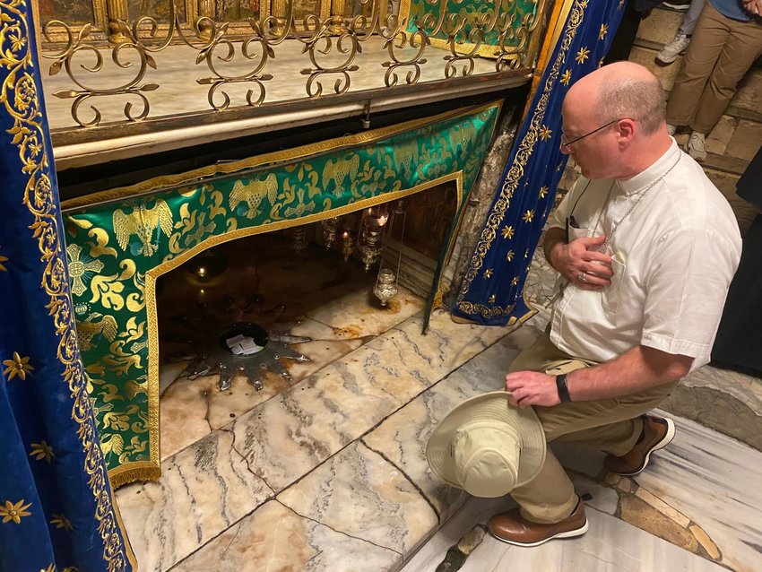 Bishop W. Shawn McKnight visits the place where Jesus was born, indicated by the star in the floor, during a recent pilgrimage to the Holy land.