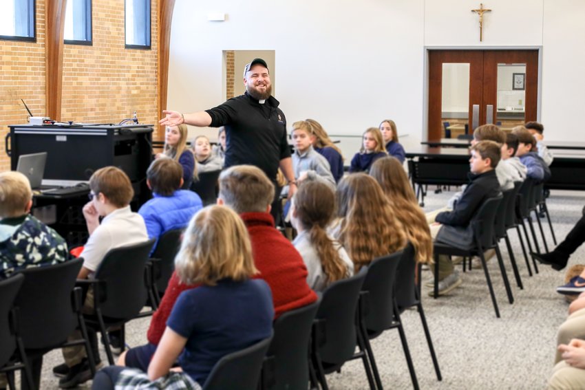 Fr. Paul Clark speaks to the sixth-grade class of St. Joseph Cathedral School on-site at Catholic Charities&rsquo; central offices in Jefferson City for a day of service and reflection.