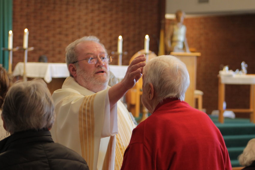 Father Michael Penn, pastor of Our Lady of the Lake Parish in Lake Ozark, administer the Sacrament of Anointing of the Sick during a Mass on Feb. 12, the World Day of the Sick, in Our Lady of the Lake Church.
