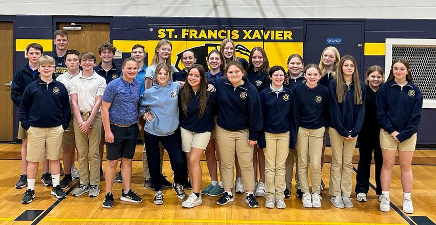 Students at St. Francis Xavier School in Taos gather in the gym after signing, addressing and mailing 700 invitations for people to come back to Mass if they&rsquo;ve been away.