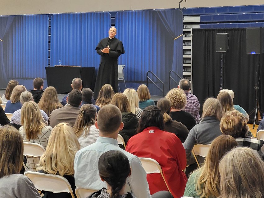 Renowned speaker Father Tony Ricard, pastor of St. Gabriel the Archangel Parish and campus minister at St. Augustine High School, both in New Orleans, entertains and uplifts the Catholic school teachers and administrators during his keynote at a March 10 teachers&rsquo; in-service in Columbia.