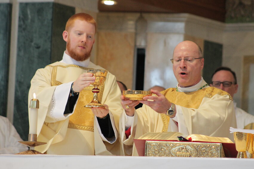 Bishop McKnight and Rev. Mr. Hoffmann elevate the Most Blessed Sacrament during the consecration at Mass following Rev. Mr. Hoffmann's ordination to the Diaconate.