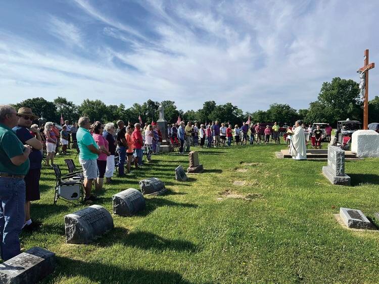 Nearly 100 members and guests of Holy Rosary and St. Stephen parishes gather for Holy Mass on Memorial Day in Holy Rosary Cemetery in Monroe City.