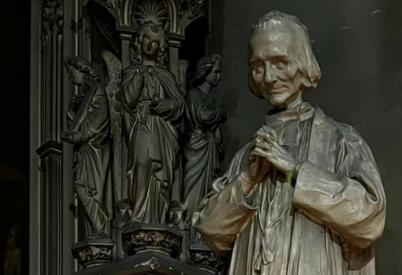 An image of St. John Vianney, patron saint of parish priests, adorns the church where he ministered with miraculous results from 1818 until his death in 1859.