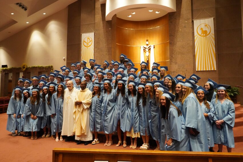Father Tolton Regional Catholic High School&rsquo;s Class of 2023 gathers for a photo with Father Michael Coleman and Father Ignatius Nimwesiga, school chaplains, May 12 after their Baccalaureate Mass in Our Lady of Lourdes Church in Columbia.