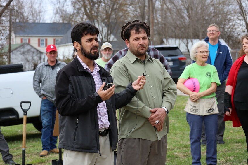 Catholic Charities Refugee Services Case Manager, Sardar Sherzad (Left), stands with and interprets for Sheen Gul Safi (right), who addressed the crowd gathered with remarks of gratitude at the groundbreaking of the Safi family&rsquo;s home.