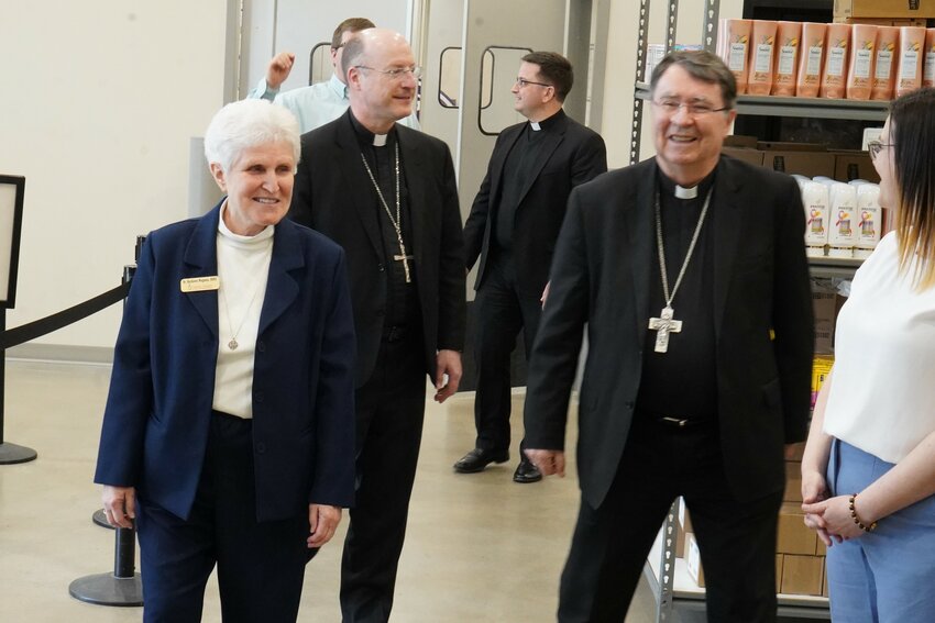 Archbishop Christophe Pierre, right, apostolic nuncio to the United States, tours Catholic Charities of Central and Northern Missouri&rsquo;s (CCCNMO&rsquo;s)Client Choice Food Pantry in Jefferson City on May 4, with Sister Kathleen Wegman SSND, CCCNMO interim executive director, and Bishop W. Shawn McKnight. Six weeks later, Archbishop Pierre mentioned what he saw in an address to the U.S. Catholic bishops.