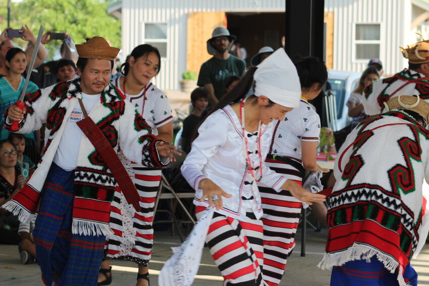 Members of the Rvwang tribe from Myanmar perform a traditional dance of thanksgiving during the World Refugee Day celebration June 24 in Columbia.