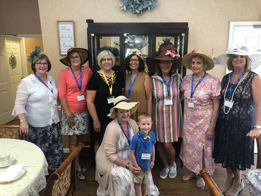 Members of the Women&rsquo;s Ministry group of St. Martin Parish in St. Martins, accompanied by their young chaperone, prepare to share high tea with residents of Westbrook Terrace in Jefferson City June 12.