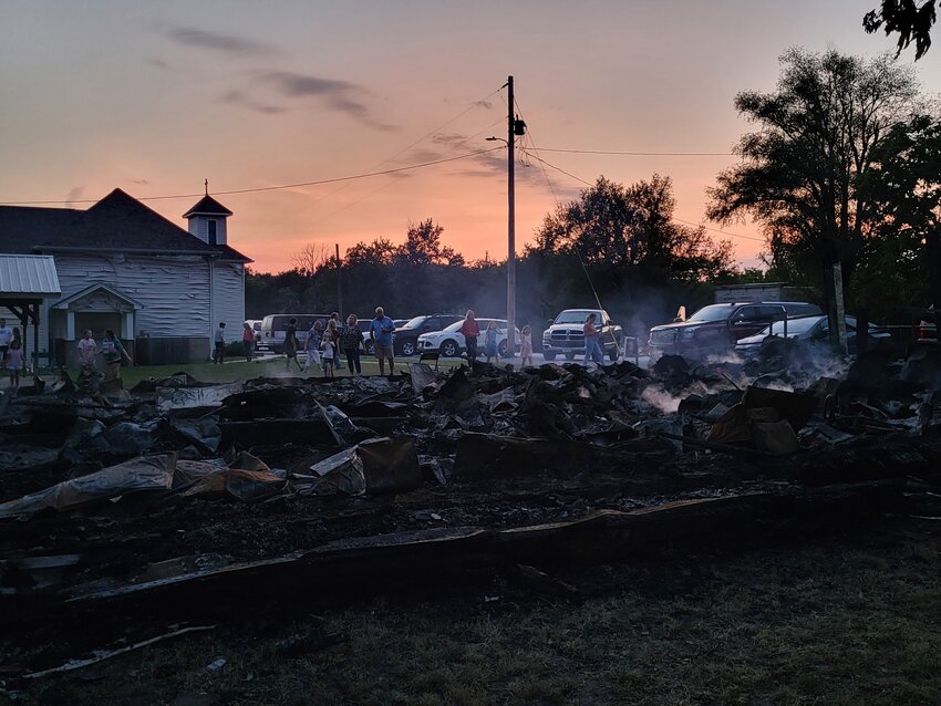 Smoldering ruins were all that remained of the 142-year-old St. John the Evangelist Chapel in Bahner, part of St. Vincent de Paul Parish of Pettis County, the evening of Aug. 1, as parishioners stopped to consider what was lost in an early-morning blaze that was sparked by lightning.