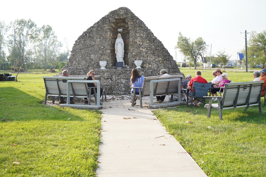 Members and friends of the former Mission of St. Aloysius in Baring gather to pray the Rosary around a Marian grotto in Baring that was built in 1955. The weekly Tuesday-evening prayers continued in the aftermath of a recent tornado.