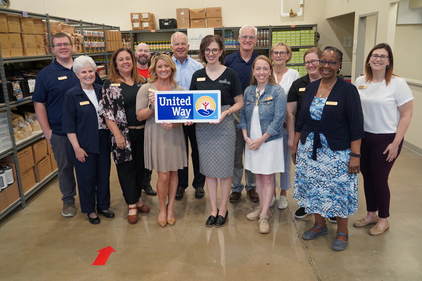 Members of the Catholic Charities staff gathers to celebrate after an Aug. 29 at a press conference in the Catholic Charities Food Pantry in Jefferson City, to announce a new partnership between the United Way and Catholic Charities of Central and Northern Missouri  and two other local agencies.