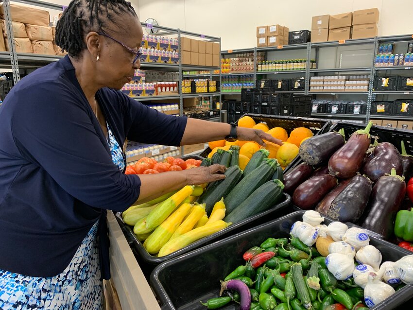 Health and Nutrition Services Director, Judith Mutamba, organizes produce in the Catholic Charities Food Pantry. With support from local donations and The Food Bank for Central and Northeast Missouri, the pantry is able to offer fresh produce, dairy products and protein options every week.