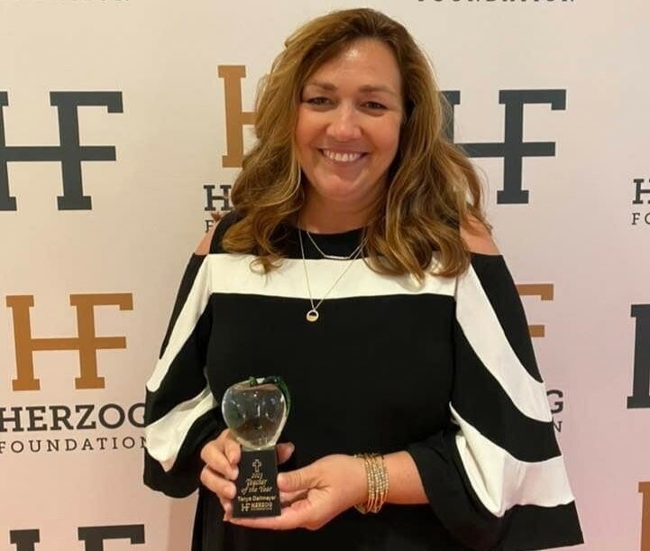 Tanya Dallmeyer, a second grade teacher at St. Peter School in Jefferson City, displays the Christian Teacher of the Year Award from the Stanley M. Herzog Charitable Foundation in Washington, D.C.