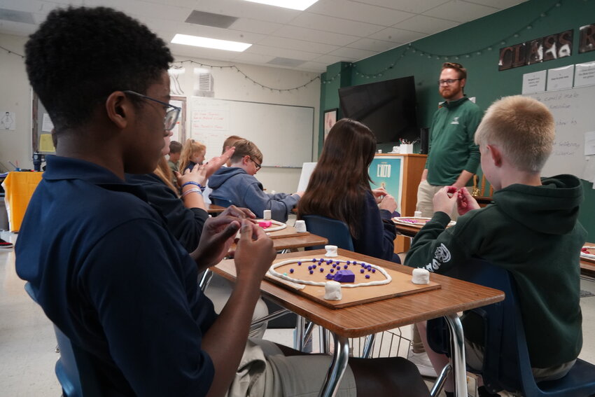 Students in Joe Powers&rsquo;s eighth-grade religion class at St. Joseph Cathedral School in Jefferson City create their own rosaries out of clay as part of an annual tradition that began over 20 years ago. The clay beads will be baked solid and strung onto fishing line.