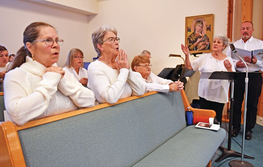 A specially-convened parish choir sing the Communion hymn during a Mass with Bishop W. Shawn McKnight to celebrate the 50th anniversary of St. Bernadette Parish in Hermitage, in the southwestern corner of the diocese.