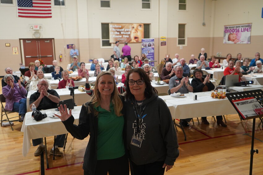 Heather Gardner, director of campaign advancement for 40 Days for Life 365, and Kathy Forck, campaign director for Columbia 40 Days for Life, turn toward the photographer while the audience applauds after Ms. Gardner&rsquo;s keynote at the Columbia 40 Days for Life  Closing Rally and Dinner Nov. 4 in the St. Andrew Parish Hall in Holts Summit.