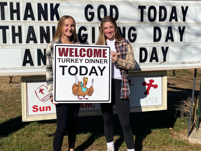 Volunteers at St. Anthony Church in Camdenton display the sign for the parish&rsquo;s 18th annual free Thanksgiving meal.