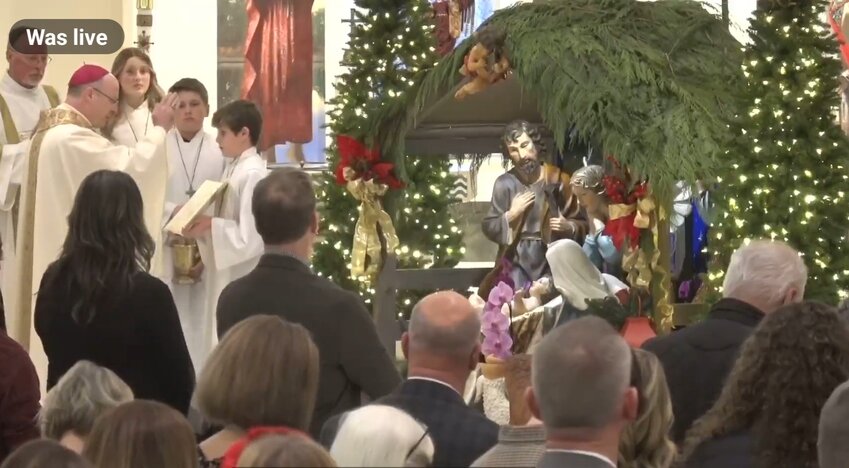 Bishop McKnight blesses the Nativity scene during the Christmas Vigil Mass in the Cathedral of St. Joseph.