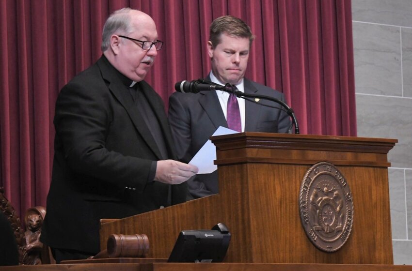Msgr. Robert A. Kurwicki, vicar general of the Jefferson City diocese, pastor of St. Peter Parish in Jefferson City, and chaplain of the Missouri House of Representatives, leads the House in praying the following prayer on Jan. 3, the opening day of the 2024 Legislative Session. With him is House Speaker Dean Plocher.