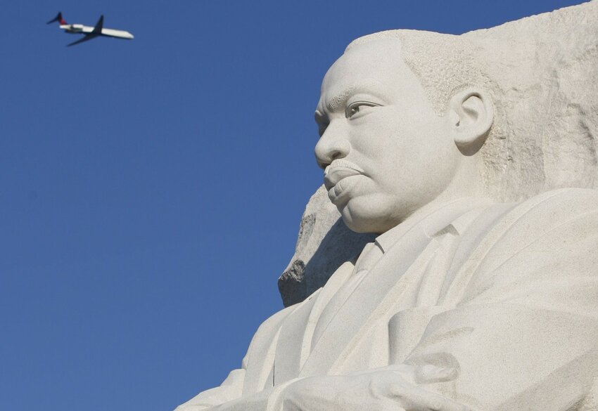 A plane flies over a 30-foot sculpture of Dr. Martin Luther King Jr. on the National Mall in Washington Aug. 22, 2011, the year it opened. As the nation celebrates the legacy of Dr. Martin Luther King Jr. on Jan. 15, 2024, both personal conversion and action are needed to build what the slain civil rights leader called &ldquo;the beloved community,&rdquo; say Catholic clergy and lay leaders.
