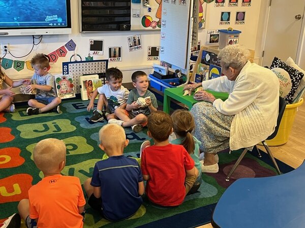 St. Mary parishioner Jane Weiland spends time as a volunteer with children in St. Mary School in Glasgow.