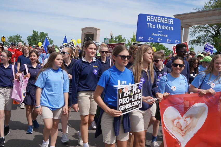 Students from Immaculate Conception School in Jefferson City, which was honored as this year&rsquo;s Pro-Life School of the Year by the Midwest March for Life organizers, walk behind the banner.