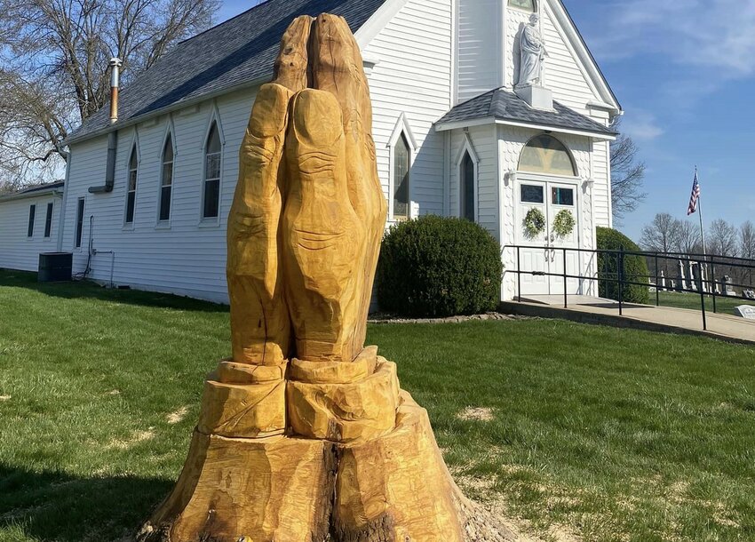 These wood-carvings depicting praying hands and St. Joseph in the churchyard of St. Joseph Church in Hurricane Branch were created in response to the trees becoming infected with a disease affecting ash trees throughout Missouri.