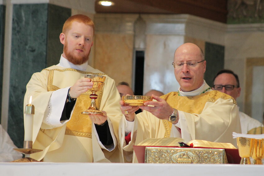 Rev. Mr. Christopher Hoffmann and Bishop W. Shawn McKnight elevate the Most Blessed Sacrament during the Mass at which Rev. Mr. Christopher Hoffmann was ordained a transitional deacon on June 3, 2023.