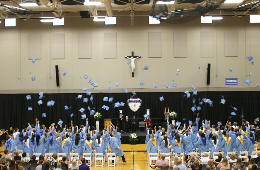 The new graduates of Fr. Tolton Regional Catholic High School in Columbia toss their mortarboards into the air during their graduation ceremony on May 19, 2024.