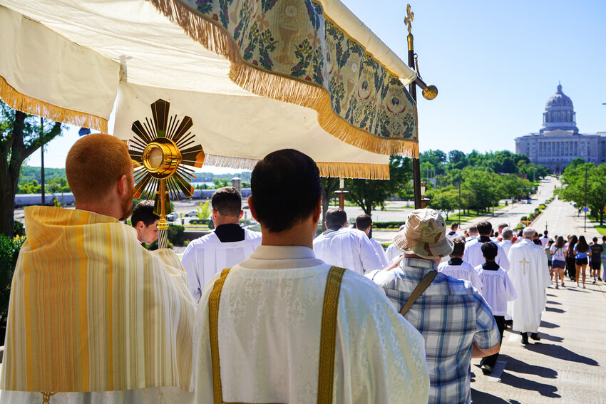 Father Christopher Hoffmann, associate pastor of Our Lady of Lourdes Parish in Columbia, carries the Most Blessed Sacrament for a portion of a Solemn Eucharistic Procession from the Cathedral of St. Joseph in Jefferson City to St. Peter Proto-Cathedral near the State Capitol July 5. Hundreds, including Bishop W. Shawn McKnight and Bishop Earl Fernandes of Columbus, Ohio, participated in the procession, which was part of the much larger National Eucharistic Pilgrimage.