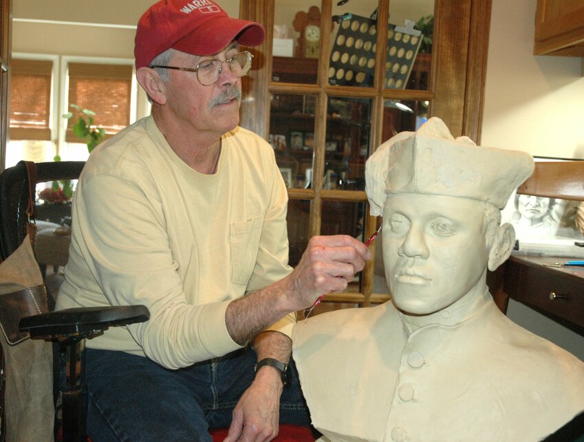 Forrest Tucker uses a sculpting knife to trim a clay bust of Father Augustus Tolton at his home in Danville, Ind., March 20, 2024. Father Tolton, a candidate for sainthood, is the first recognized priest of African descent in the United States. He was declared &ldquo;venerable&rdquo; by Pope Francis in 2019.