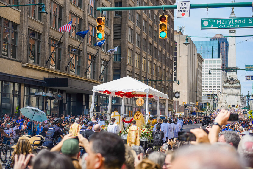 The Most Blessed Sacrament is carried in procession toward the Soldiers and Sailors Monument in Indianapolis, with thousands of people participating, on July 20 during the 10th National Eucharistic Congress.